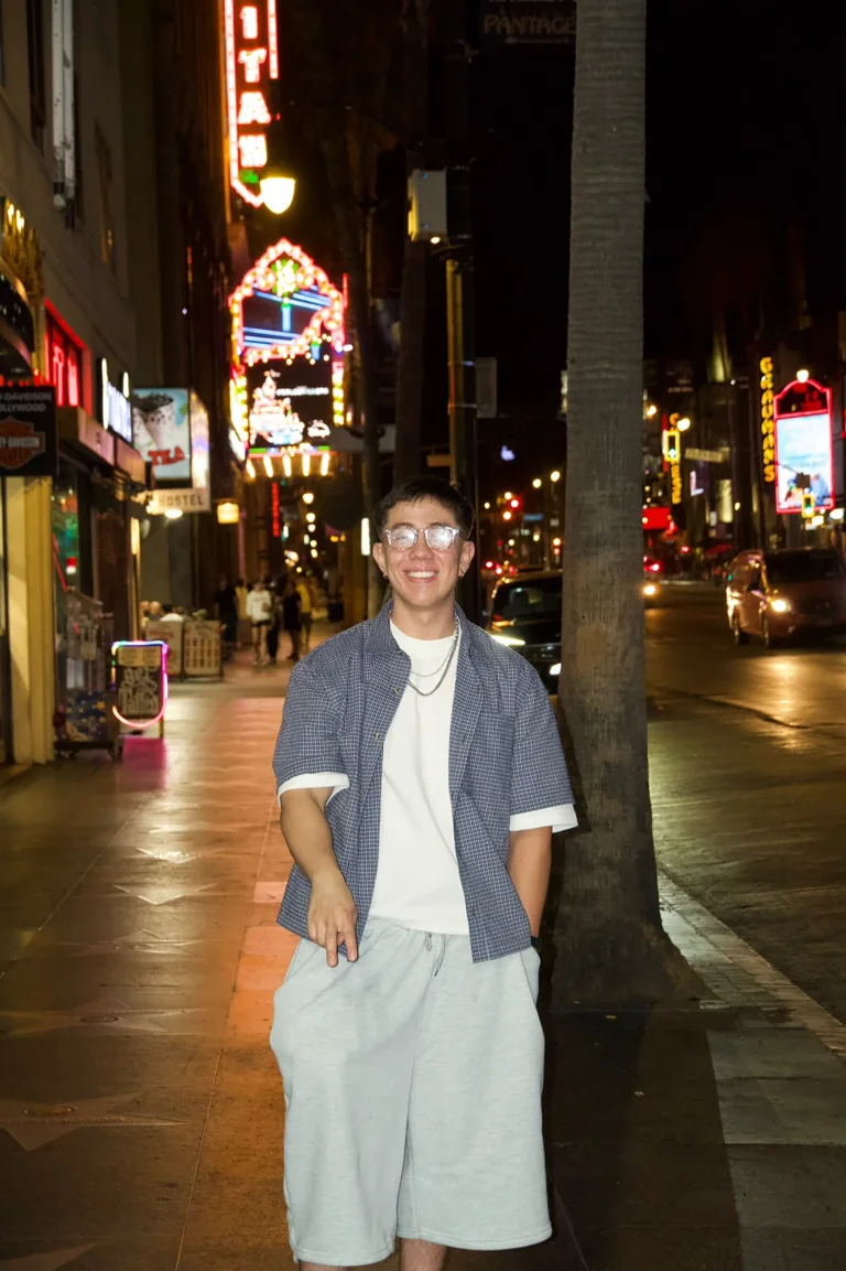 Freddy Flores smiling on a city street at night